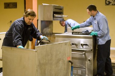 guys cleaning grease equipment